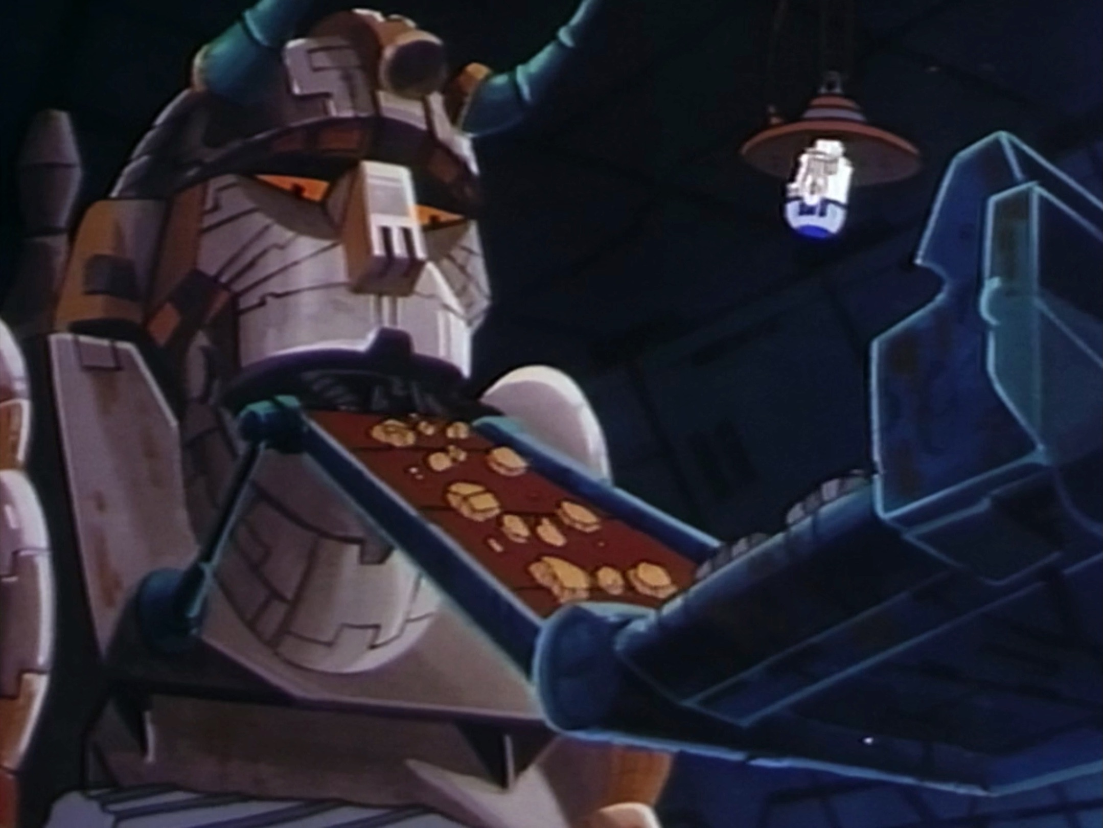 The Great Heep holds R2-D2 captive on his magnetic grapple while consuming fuel ore.