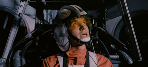 Theron Nett in the cockpit of his X-wing looking up and to the right.