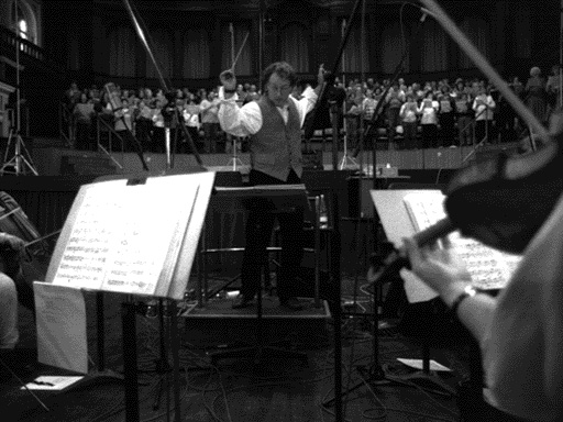 Joel McNeely conducts the orchestra and chorus.