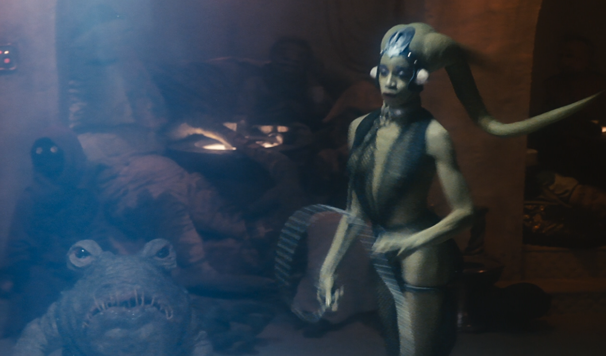 Geezum (center, top) watched Oola dance at Jabba's Palace.