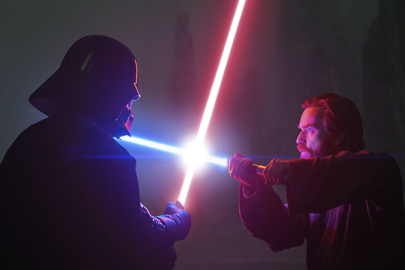 The lightsaber blades of Obi-Wan Kenobi and Darth Vader clash.