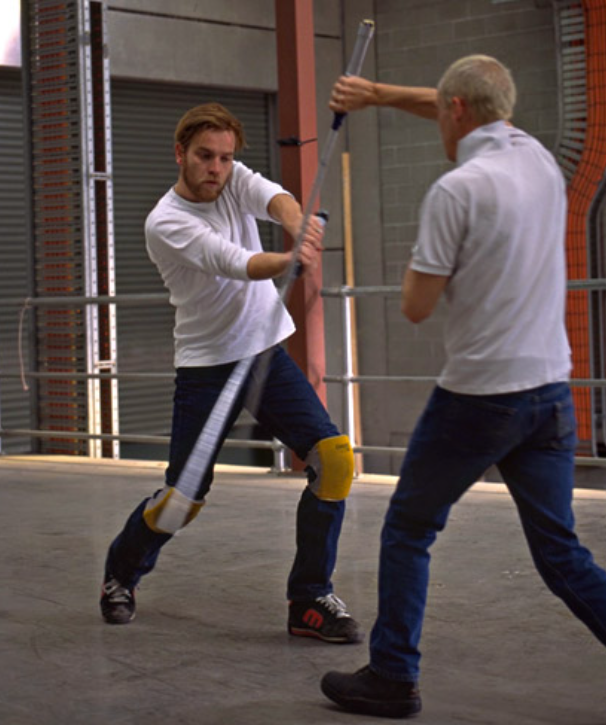 Ewan McGregor practices lightsaber combat with Stunt Coordinator Nick Gillard during production on Attack of the Clones