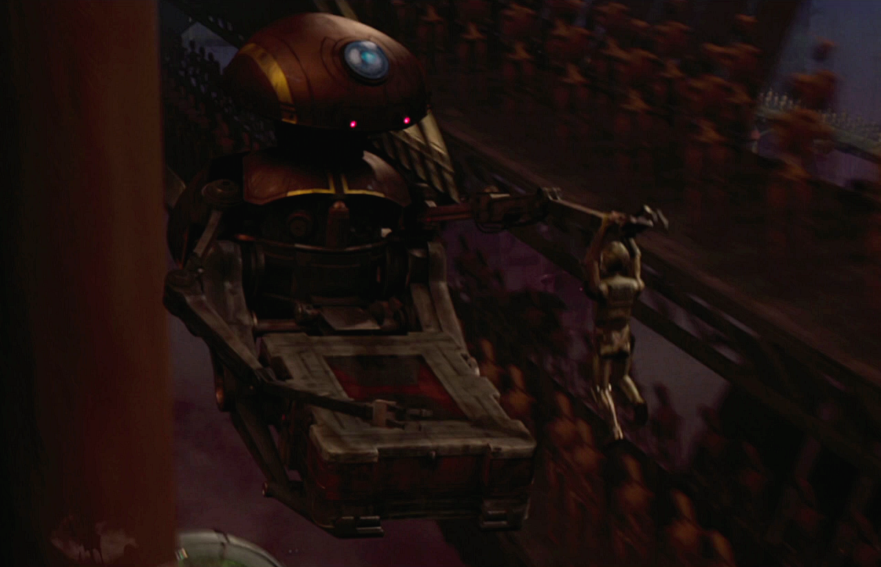 An SRT droid carries C-3PO through the droid foundry on Geonosis.