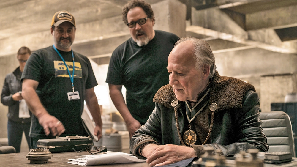 Werner Herzog in the safe house set with showrunner Jon Favreau (center) and director and producer Dave Filoni (left)