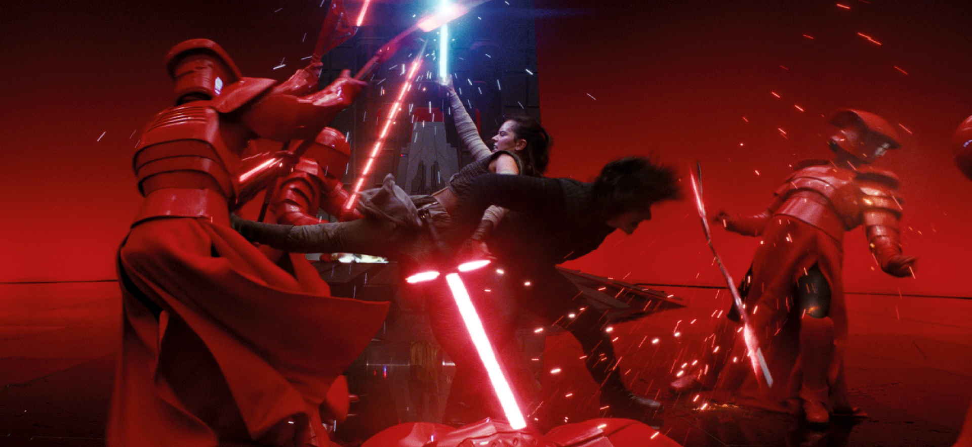 Rey and Kylo join forces against Snoke's guards.