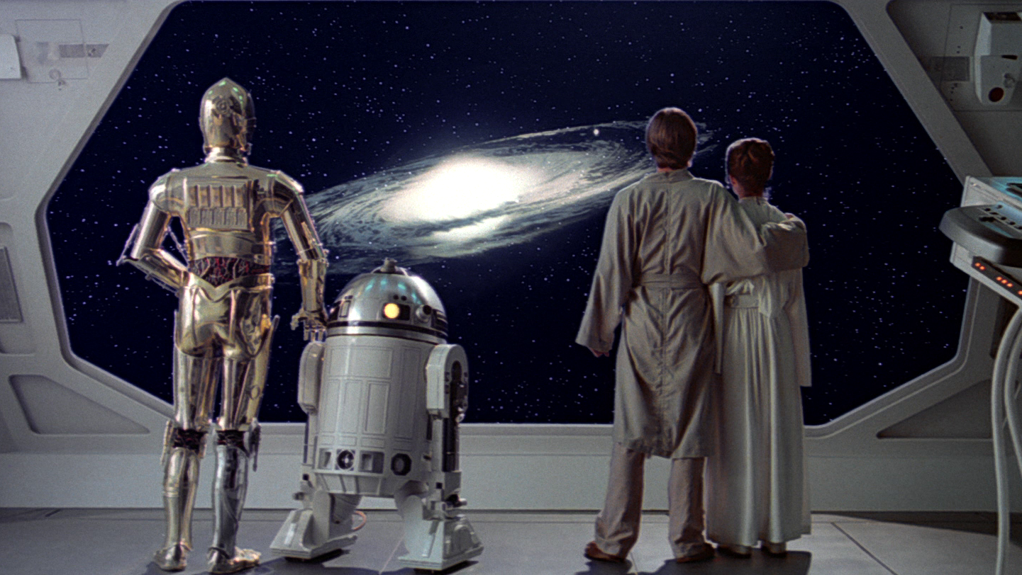 Luke Skywalker, Leia Organa, C-3PO and R2-D2 watch the Millennium Falcon depart the rendezvous point