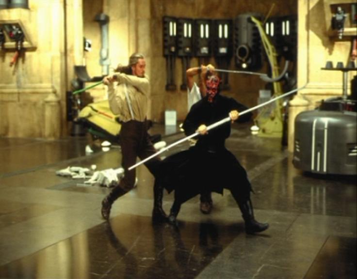 Ray Park practices dueling with the stunt doubles of Liam Neeson and Ewan McGregor.