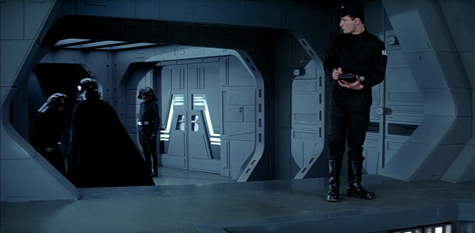 Retwin watches as the defeated Darth Vader stalks off the Executor's bridge.