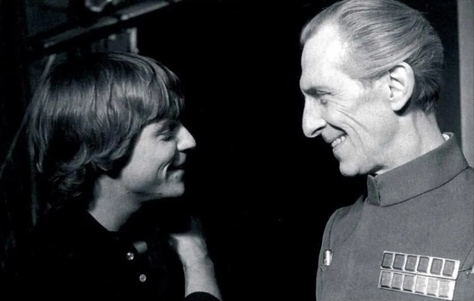 Mark Hamill and Peter Cushing interacting on the set of Star Wars