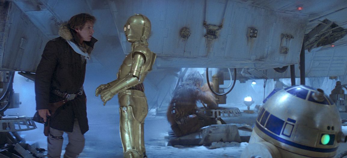 Solo converses with Threepio while repairing the Falcon alongside Chewie in Echo Base.