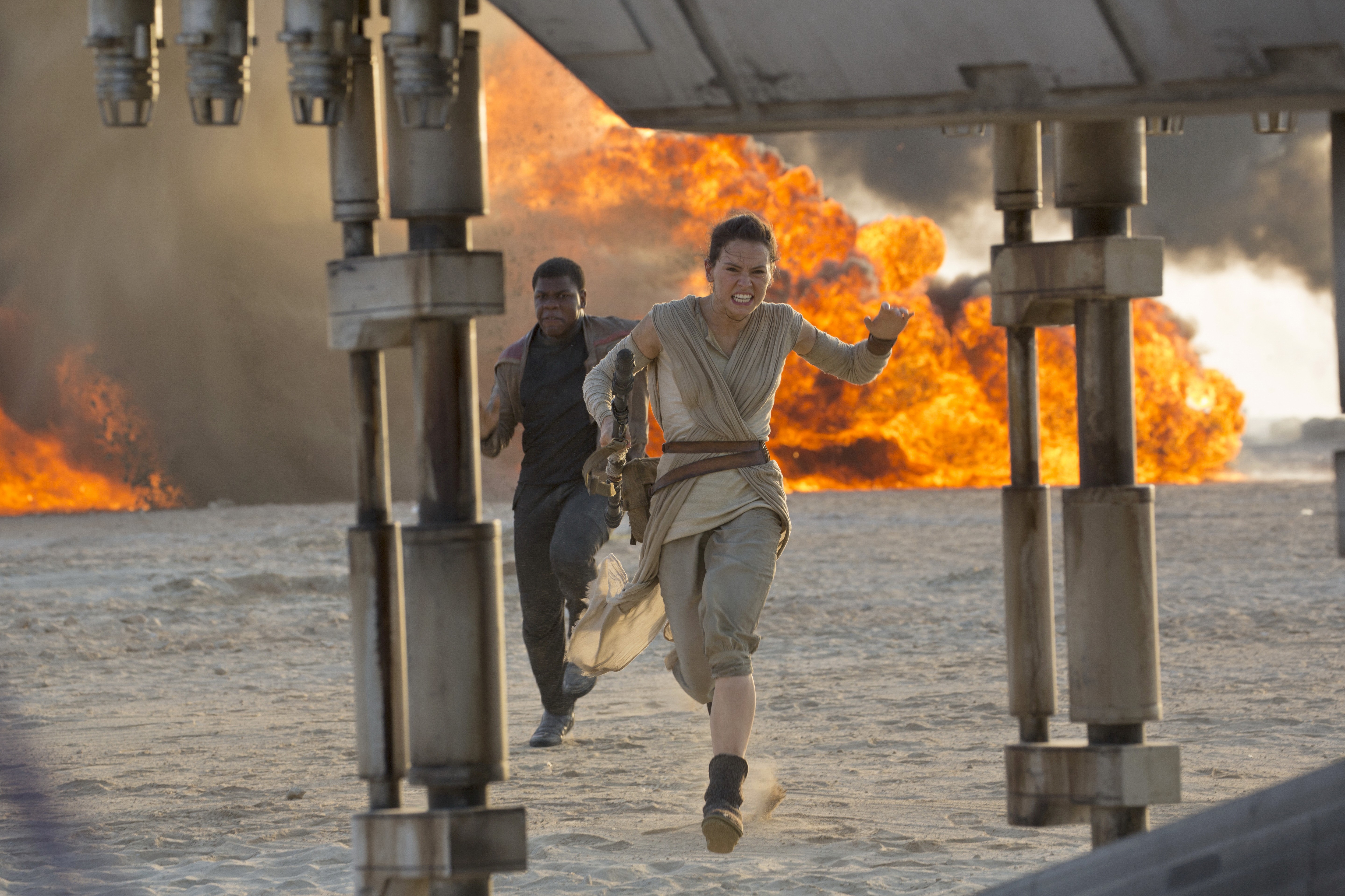 Rey and Finn race aboard the Millennium Falcon with First Order Stormtroopers and TIE fighters in hot pursuit.