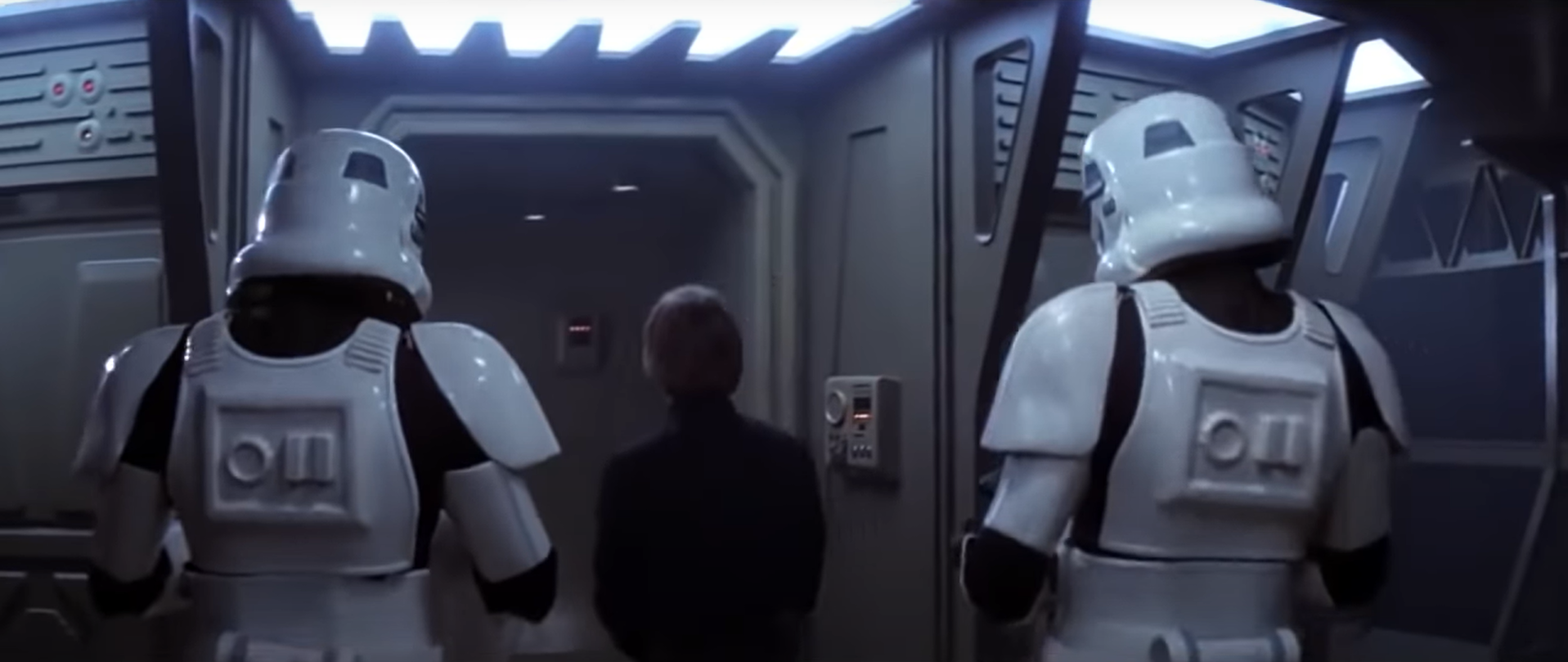 Wallen and another stormtrooper escorting Luke Skywalker into a lift.