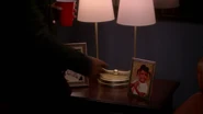 Tariq reaches for Diana's baby picture.[15]