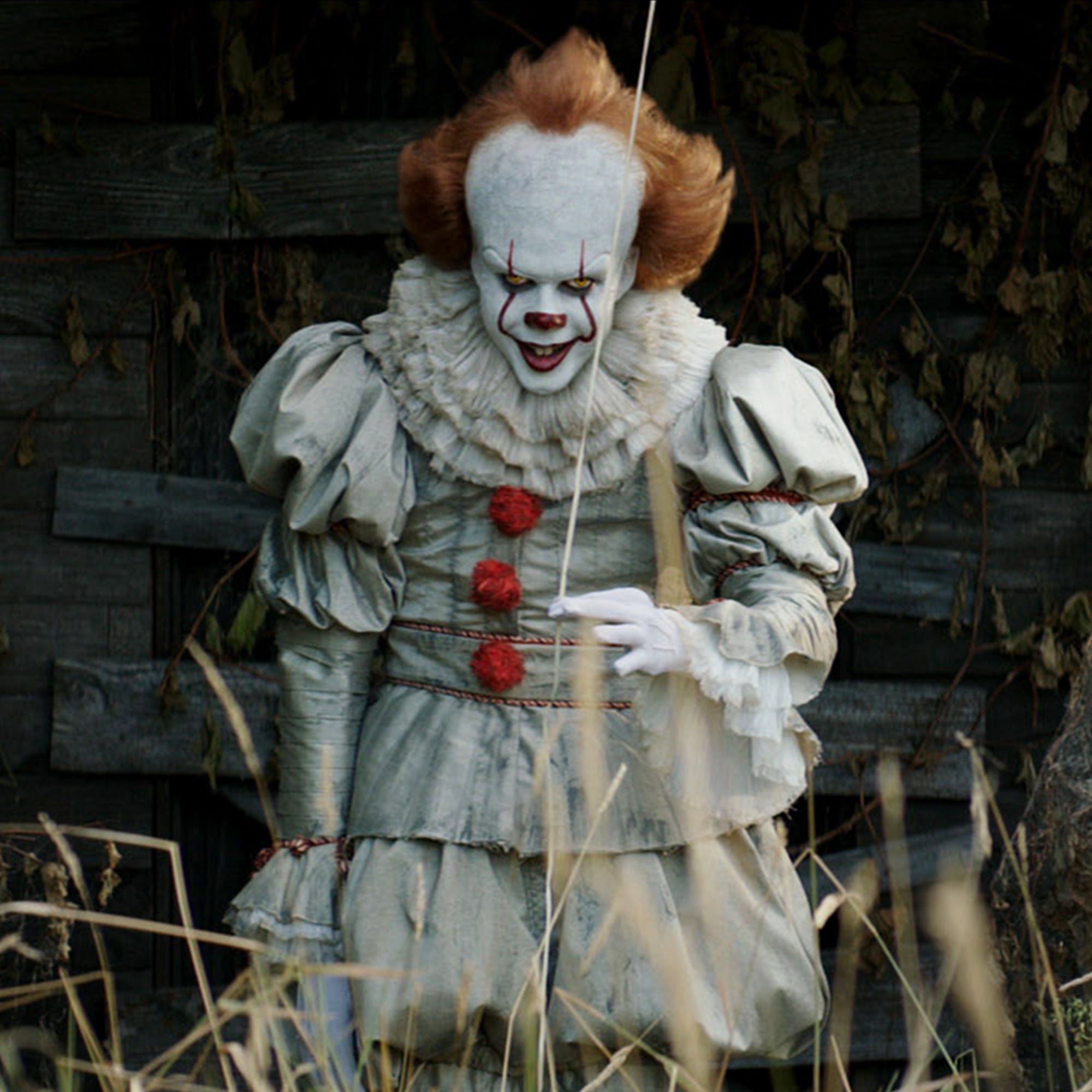 Halloween Makeup Like Pennywise. Street performer clown with a white face.  The look of a man in the guise of IT on a costume cosplay show. Close-up.  Stock Photo