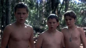 Chris, Vern and Teddy stare on at petrified Gordie extracting the leech