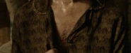 After breaking the silence, Mrs. Kersh scratches at her chest, revealing some rotted skin the process.