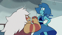 Jasper wears a desperate grin on her face as she holds the hand of Lapis, whose face wears a look of frightened surprise.