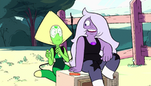 Amethyst sits on a microwave and talks to Peridot, who looks perturbed.