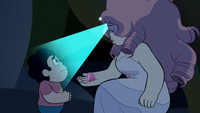 Pearl, as Rose, shines her gem on a confused Steven as she shows him Pink Diamond's gemstone.