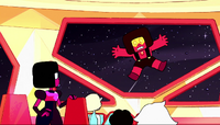 A Ruby hits the spaceship as the Crystal Gems look at her.