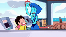 Steven and Lapis laugh as Lapis pulls the handle to blow the boat's horn.