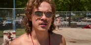Billy looking at a kid who was running along the pool.