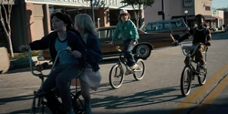 The kids bike to school, passing through downtown Hawkins.