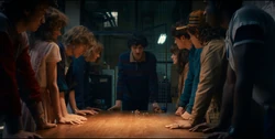 Mike explaining the plan to kidnap Derek