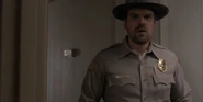 Hopper surprised to see Joyce Byers in his office.