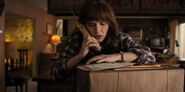 Joyce on the phone with package