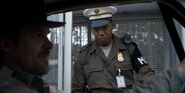 M.P. Guard Patrick stopping Chief Hopper at the Hawkins Lab main gate.