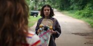 S3E2-El holding Max's skateboard