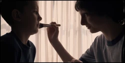 Mike applying makeup to Eleven.