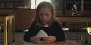 S2E1 A girl with a paper fortune teller.jpg