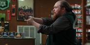 S2E7-Cashier aiming his gun