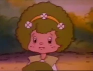 Lime Chiffon appears in Strawberry Shortcake Meets the Berrykins with a curly afro. Note that she is wearing a different dress from what she usually wears.