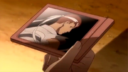 Sakura holding a photo of Ryu from Street Fighter Alpha 2.