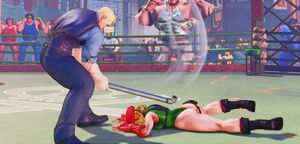 Cody bashing Cammy's back with the pipe using Secret Work.