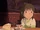 Chihiro at table with tea.png