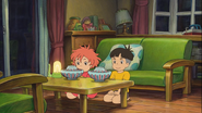 Ponyo (the guest) and Sosuke having bowls of ramen noodles.