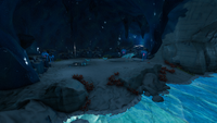 A large cave housing a pack of Snow Stalker Babies and a singular Snow Stalker