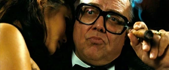 The Mayor watches as Babydoll begins her dance.