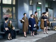 Passengers wait at the bus depot.