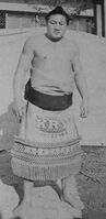 Kairyuyama poses with his kesho-mawashi (c. 1966)