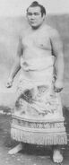 Tokitsuyama poses with his kesho-mawashi