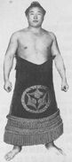 Komatsuyama poses with his kesho-mawashi