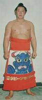 Owashi poses with his kesho-mawashi (c. 1976)