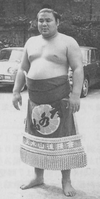 Tensuiyama poses with his kesho-mawashi