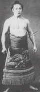 Tachiwaka poses with his kesho-mawashi