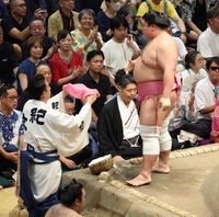 Teruya assists Ura at ringside